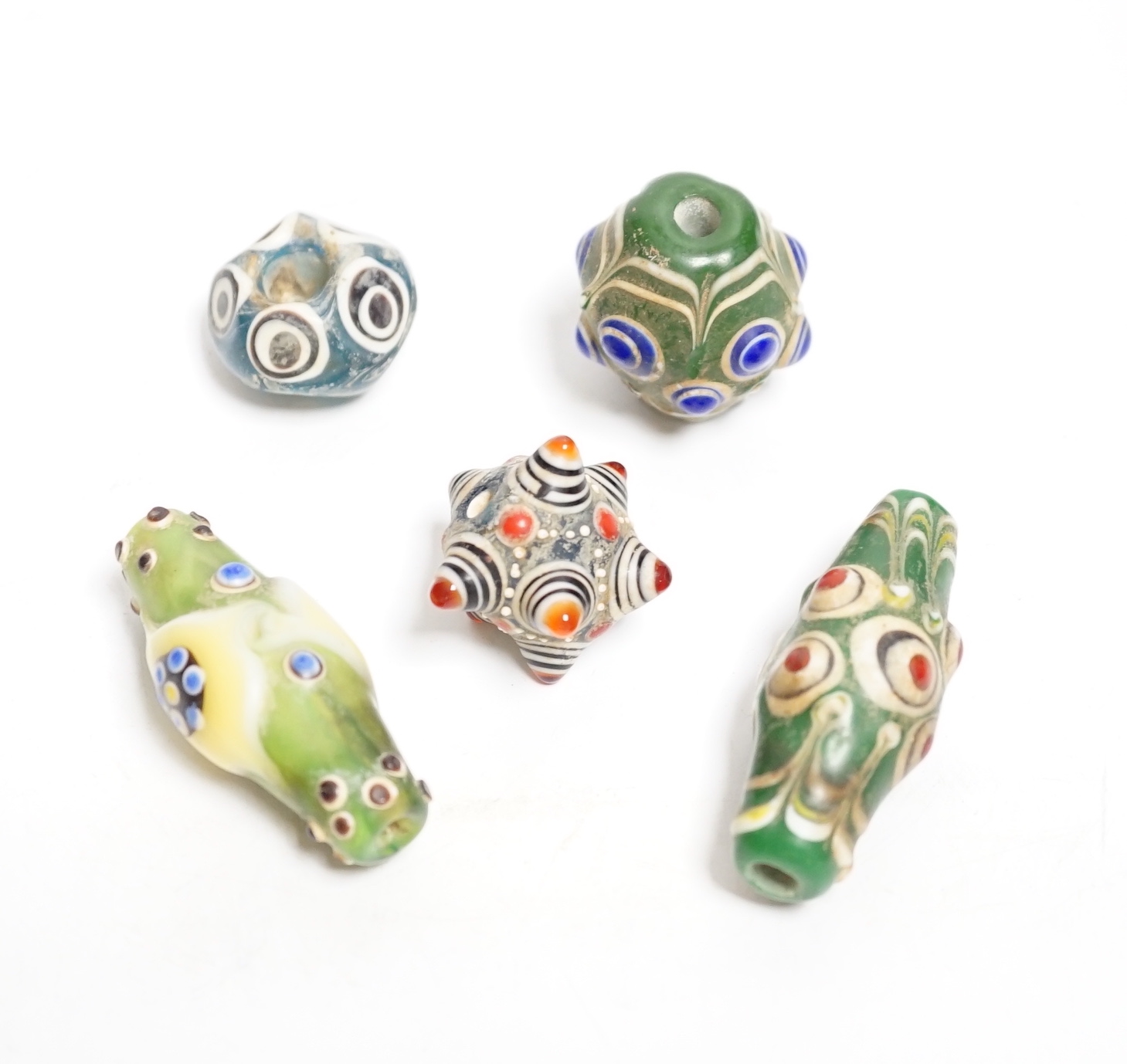 Five Eastern glass beads, largest 5.5cm long